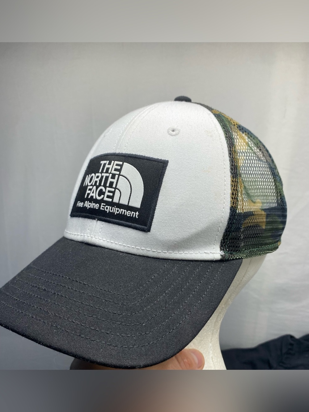 The North Face White Front Gray Brim Trucker Hat with Camo Mesh